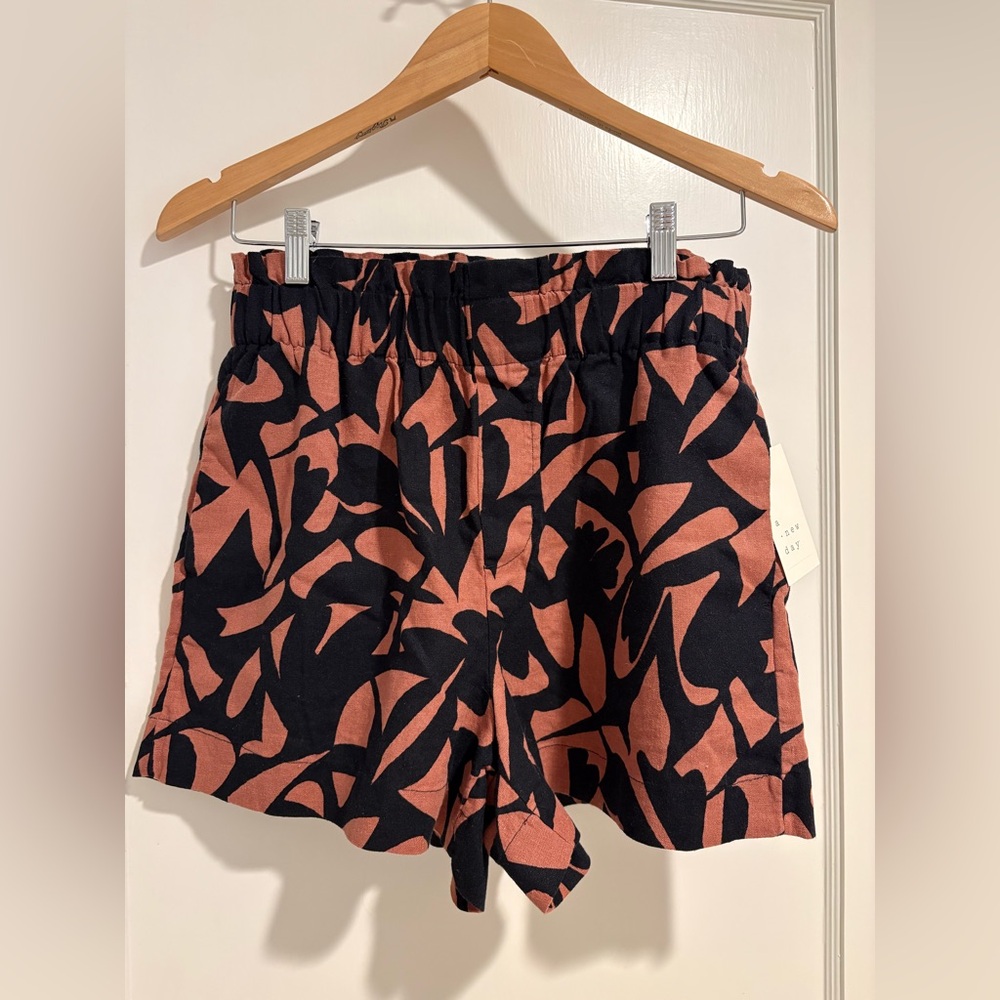 New! Orange and black pattern shorts with elastic waste. Size small.